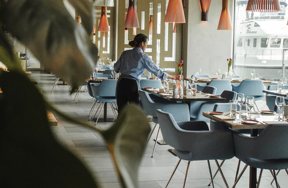 a waiter setting a table