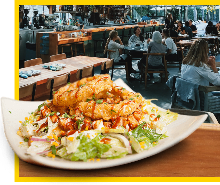 a plate of salad topped with onion rings