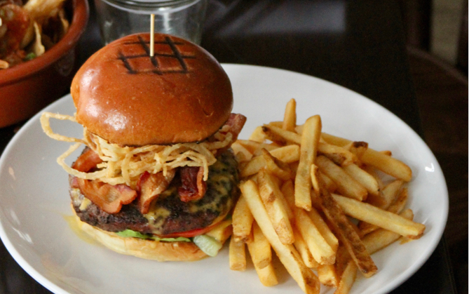 a hamburger and fries on a dinner plate